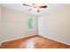 Bedroom featuring hardwood floors, a window, and neutral wall paint at 14 Gloucester Ct, Durham, NC 27713