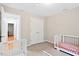 Carpeted bedroom with two cribs and closet at 14 Gloucester Ct, Durham, NC 27713