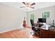 Bedroom with hardwood floors, a ceiling fan, and two windows offering backyard views at 14 Gloucester Ct, Durham, NC 27713