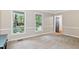 Bright bedroom features neutral colors, two large windows, and ensuite access at 14 Gloucester Ct, Durham, NC 27713