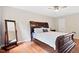 Large bedroom featuring a wood-framed mirror, hardwood floors, and comfortable bedding creating a relaxing haven at 14 Gloucester Ct, Durham, NC 27713
