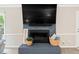 Living room fireplace boasts a large mounted television and stylish decor creating a cozy focal point at 14 Gloucester Ct, Durham, NC 27713