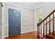 Warm and inviting foyer with hardwood floors, a blue front door, and staircase, creating a welcoming entrance at 14 Gloucester Ct, Durham, NC 27713