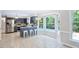 Open kitchen with breakfast bar, stainless appliances, and view of the outdoor pool at 14 Gloucester Ct, Durham, NC 27713