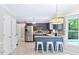 Open kitchen features stainless appliances, breakfast bar, and view of the pool at 14 Gloucester Ct, Durham, NC 27713