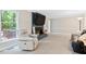 Relaxing living room has cozy chair near the brick fireplace, perfect for unwinding and indoor comfort at 14 Gloucester Ct, Durham, NC 27713