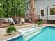 The pool features walk in steps with a seating area at 14 Gloucester Ct, Durham, NC 27713