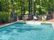 A beautiful in-ground pool sits next to a raised deck with seating at 14 Gloucester Ct, Durham, NC 27713