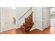 Elegant staircase with hardwood steps and white trim leading to the upper level, enhancing the home's interior design at 14 Gloucester Ct, Durham, NC 27713