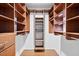 Organized walk-in closet featuring custom shelving and drawers providing efficient storage solutions at 14 Gloucester Ct, Durham, NC 27713