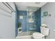 Bathroom featuring a glass shower with blue tile surround and a pebble floor at 1420 Seabrook Ave, Cary, NC 27511