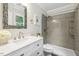Updated bathroom with shower and tub, modern vanity, silver fixtures, and decorative mirror at 1420 Seabrook Ave, Cary, NC 27511