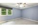 Bright bedroom featuring neutral-colored walls and a window with outdoor views at 1420 Seabrook Ave, Cary, NC 27511