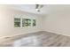 Serene bedroom featuring beautiful hardwood floors, large windows, and abundant natural light at 1420 Seabrook Ave, Cary, NC 27511
