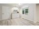 Bright dining room features wood floors, a modern art piece, and natural light from a window at 1420 Seabrook Ave, Cary, NC 27511