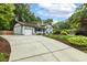 Home featuring a long driveway, Tudor-style architecture, and meticulously maintained landscaping at 1420 Seabrook Ave, Cary, NC 27511