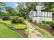 The home has a stone pathway leading to the Tudor-style house surrounded by well-maintained greenery at 1420 Seabrook Ave, Cary, NC 27511