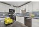 Kitchen boasts modern appliances, granite countertops, and an eye-catching black and white backsplash at 1420 Seabrook Ave, Cary, NC 27511
