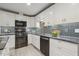 Stylish kitchen showcases updated appliances, sleek black countertops, and eye-catching backsplash at 1420 Seabrook Ave, Cary, NC 27511