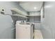 Laundry area equipped with a washer, dryer, and shelving for optimal storage space at 1420 Seabrook Ave, Cary, NC 27511