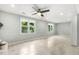 Well-lit living room featuring tile flooring and views of lush outdoor greenery from the windows at 1420 Seabrook Ave, Cary, NC 27511