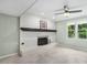 Cozy living area with brick fireplace, recessed lighting, and a window overlooking the backyard at 1420 Seabrook Ave, Cary, NC 27511