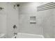 Updated shower with white tiling, built-in shelves, and a showerhead fixture at 1420 Seabrook Ave, Cary, NC 27511