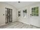 Sun room features hardwood floors, several windows, a glass slider, and a door to the backyard at 1420 Seabrook Ave, Cary, NC 27511