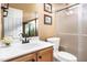 Well-maintained bathroom with a single vanity, framed mirror, and tiled shower enclosure for a fresh and clean experience at 1603 Timber Wolf Dr, Durham, NC 27713