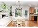 Cozy breakfast nook featuring a chandelier, fireplace, and large windows, offering a delightful dining area at 1603 Timber Wolf Dr, Durham, NC 27713