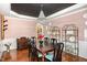Elegant dining room featuring hardwood floors, a crystal chandelier, and stylish decor at 1603 Timber Wolf Dr, Durham, NC 27713