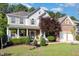 Charming two-story home featuring a brick and siding exterior, a two-car garage, and a beautifully landscaped front yard at 1603 Timber Wolf Dr, Durham, NC 27713