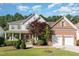 Charming two-story home featuring a brick and siding exterior, a two-car garage, and a beautifully landscaped front yard at 1603 Timber Wolf Dr, Durham, NC 27713
