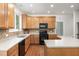 Charming kitchen featuring wood cabinets, stainless steel appliances, and a tiled backsplash, combining style with functionality at 1603 Timber Wolf Dr, Durham, NC 27713
