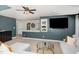 Cozy living room featuring a ceiling fan, and a built in shelving unit adjacent to the television at 1603 Timber Wolf Dr, Durham, NC 27713