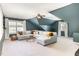 Living room featuring high ceilings, bright windows, and comfortable sectional providing style and space at 1603 Timber Wolf Dr, Durham, NC 27713