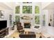 Bright living room with soaring ceilings, large windows, a cozy fireplace, and comfortable seating at 1603 Timber Wolf Dr, Durham, NC 27713