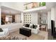 Bright living room with hardwood floors, white sofa, and a decorative gallery wall, offering a cozy and stylish gathering space at 1603 Timber Wolf Dr, Durham, NC 27713