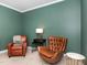 Inviting office space with neutral carpeting, green walls, natural light, and comfortable armchairs at 1603 Timber Wolf Dr, Durham, NC 27713