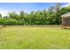 Spacious backyard with lush green grass and a wooden fence, offering privacy and room to roam at 18 Dot Dr, Wendell, NC 27591