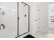 Modern bathroom showcases a glass-enclosed shower with black fixtures, combining style and functionality at 18 Dot Dr, Wendell, NC 27591