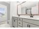 Bright bathroom features a double vanity with white countertops and black fixtures, next to an open toilet space at 18 Dot Dr, Wendell, NC 27591