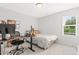 Bright bedroom with a bed, desk and computer, showcasing a comfortable and functional space for work or relaxation at 18 Dot Dr, Wendell, NC 27591