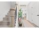 Inviting entryway with a staircase and decorative 'Home Sweet Home' decor, leading to kitchen at 18 Dot Dr, Wendell, NC 27591
