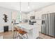 Modern kitchen featuring an island with seating, stainless appliances, and pendant lighting at 18 Dot Dr, Wendell, NC 27591