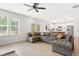 Spacious living room features a large sectional, light wood floors, and open floor plan to the modern kitchen at 18 Dot Dr, Wendell, NC 27591