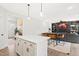 Open-concept kitchen leading to the living room with dining area, fireplace, and television at 18 Dot Dr, Wendell, NC 27591
