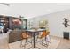 Open-concept living room with dining area, fireplace, shelving, and sliding door to the patio at 18 Dot Dr, Wendell, NC 27591