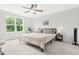 Spacious main bedroom features a ceiling fan, a large window, and neutral decor creating a serene environment at 18 Dot Dr, Wendell, NC 27591