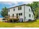 Back of the home with a wood deck, stucco siding, and black trimmed windows at 18 W Academy St, Wendell, NC 27591